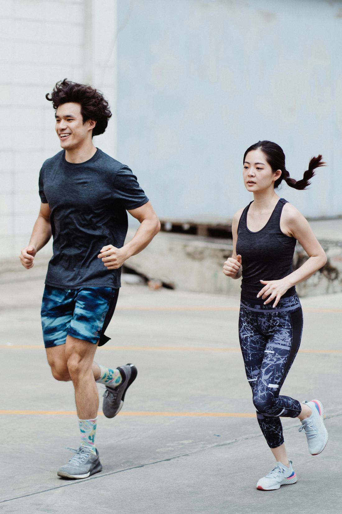 Two people running through the city
