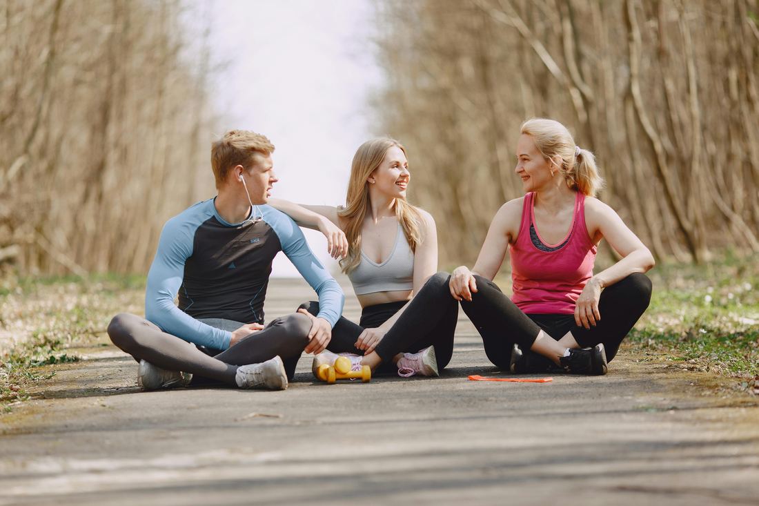 Three friends taking a break on a trail